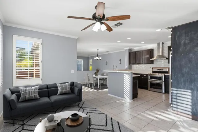 a living room with furniture kitchen and a window