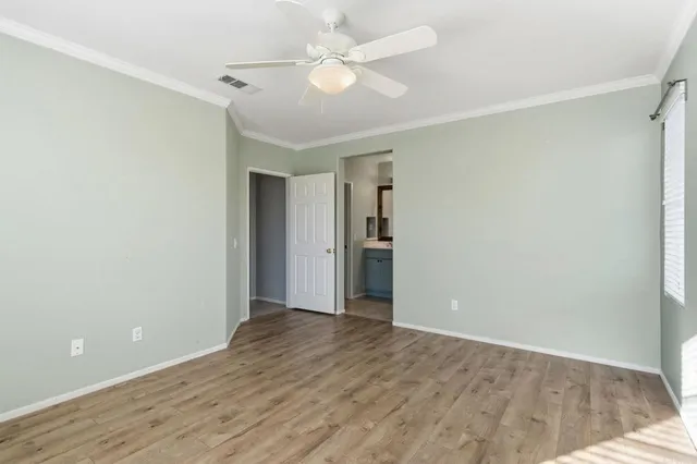 a view of an empty room with a ceiling fan