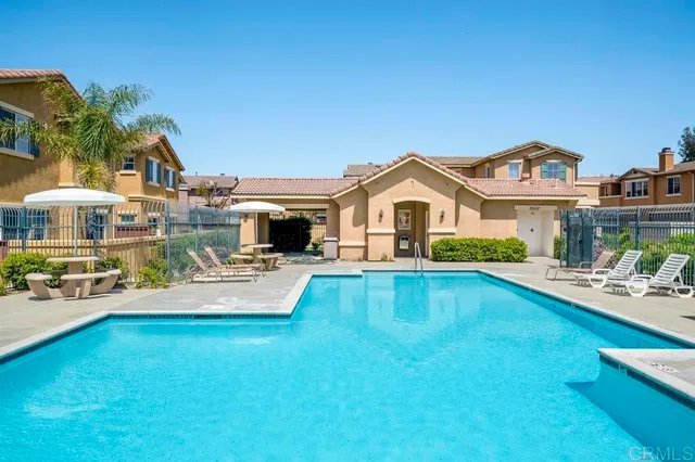 a view of a house with swimming pool yard and sitting area