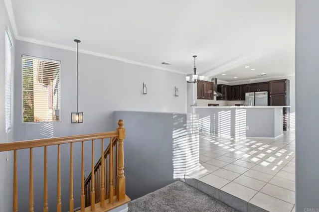 a open kitchen with white cabinets and window
