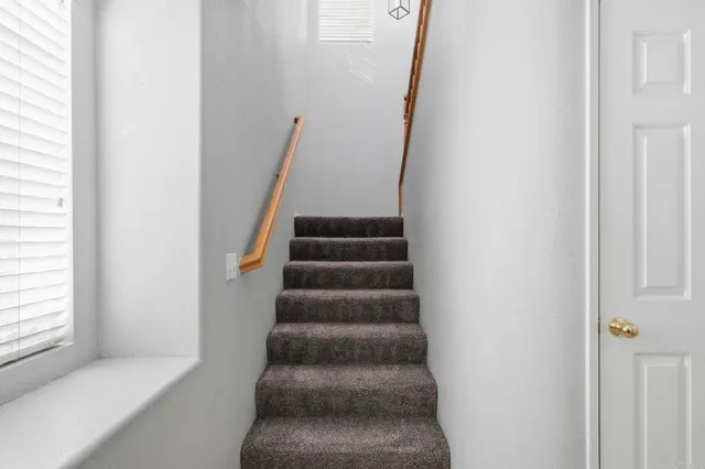 a view of staircase with white walls