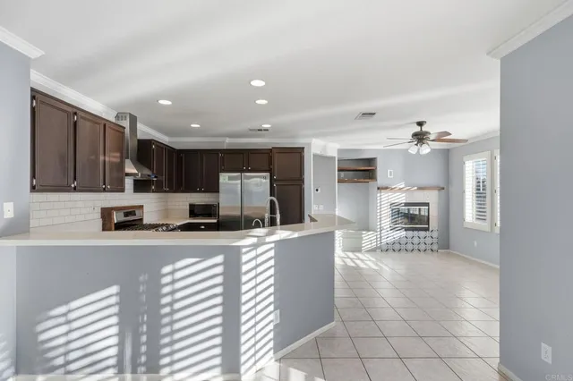 a kitchen with stainless steel appliances a refrigerator sink and microwave