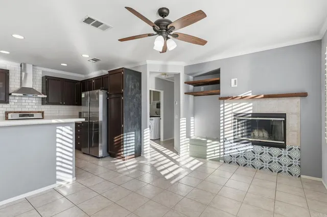 a kitchen with stainless steel appliances granite countertop a refrigerator a oven and a stove