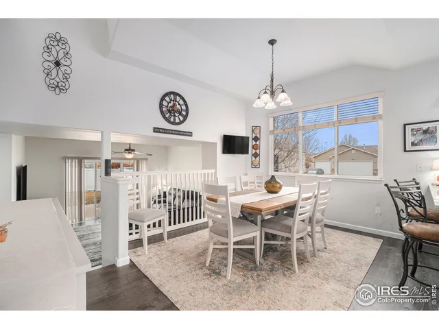 a dining room with a wooden table and chairs
