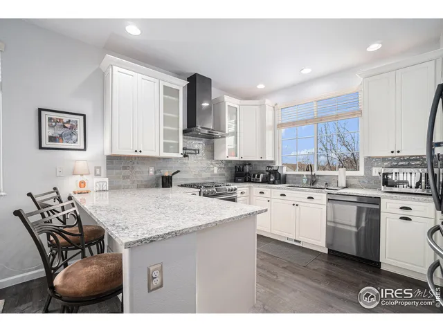 a kitchen with a sink stove and wooden cabinets