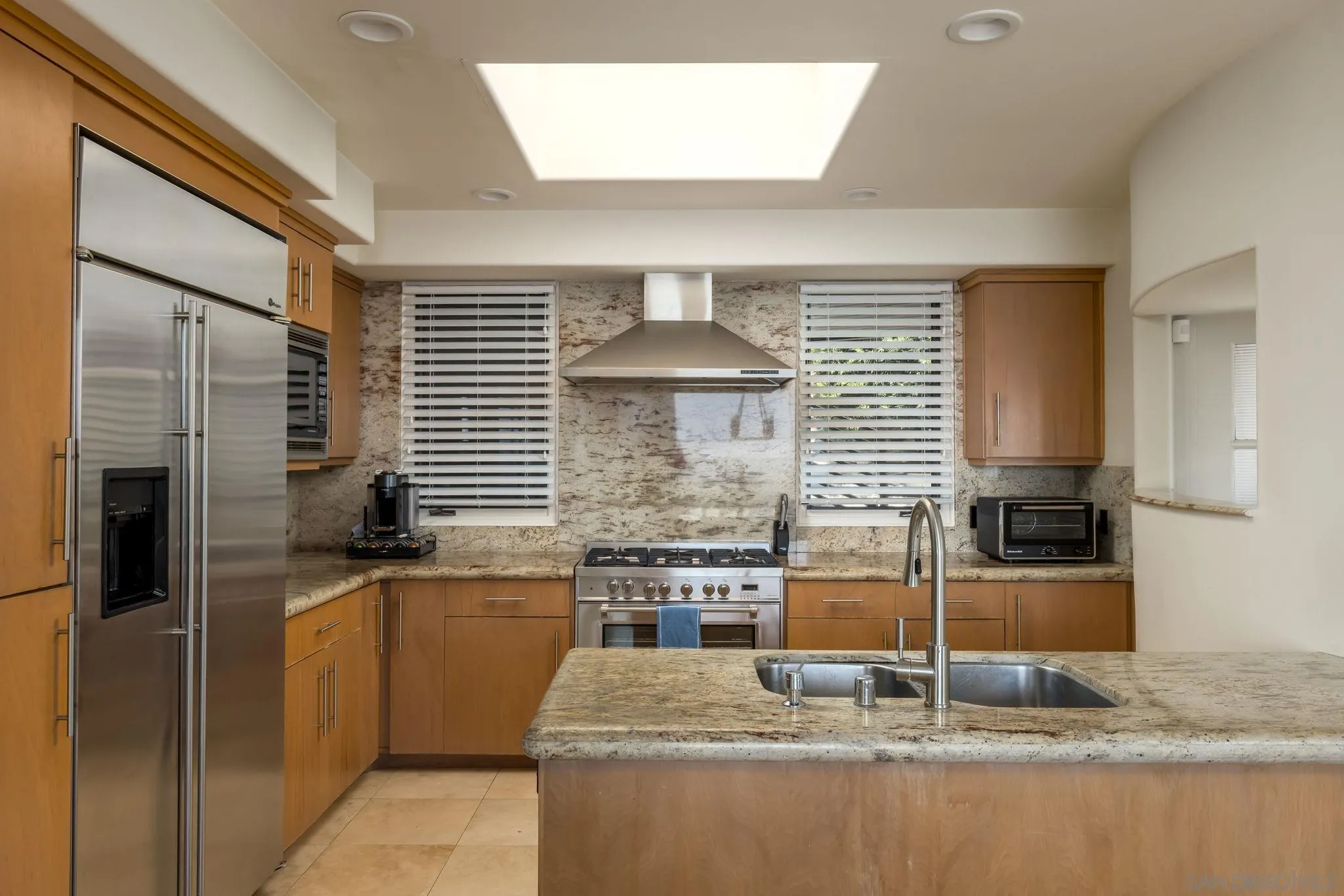 1722 Seaview Avenue Del Mar, CA 92014 - Photo 11 of 31 a kitchen with stainless steel appliances granite countertop a sink and a refrigerator