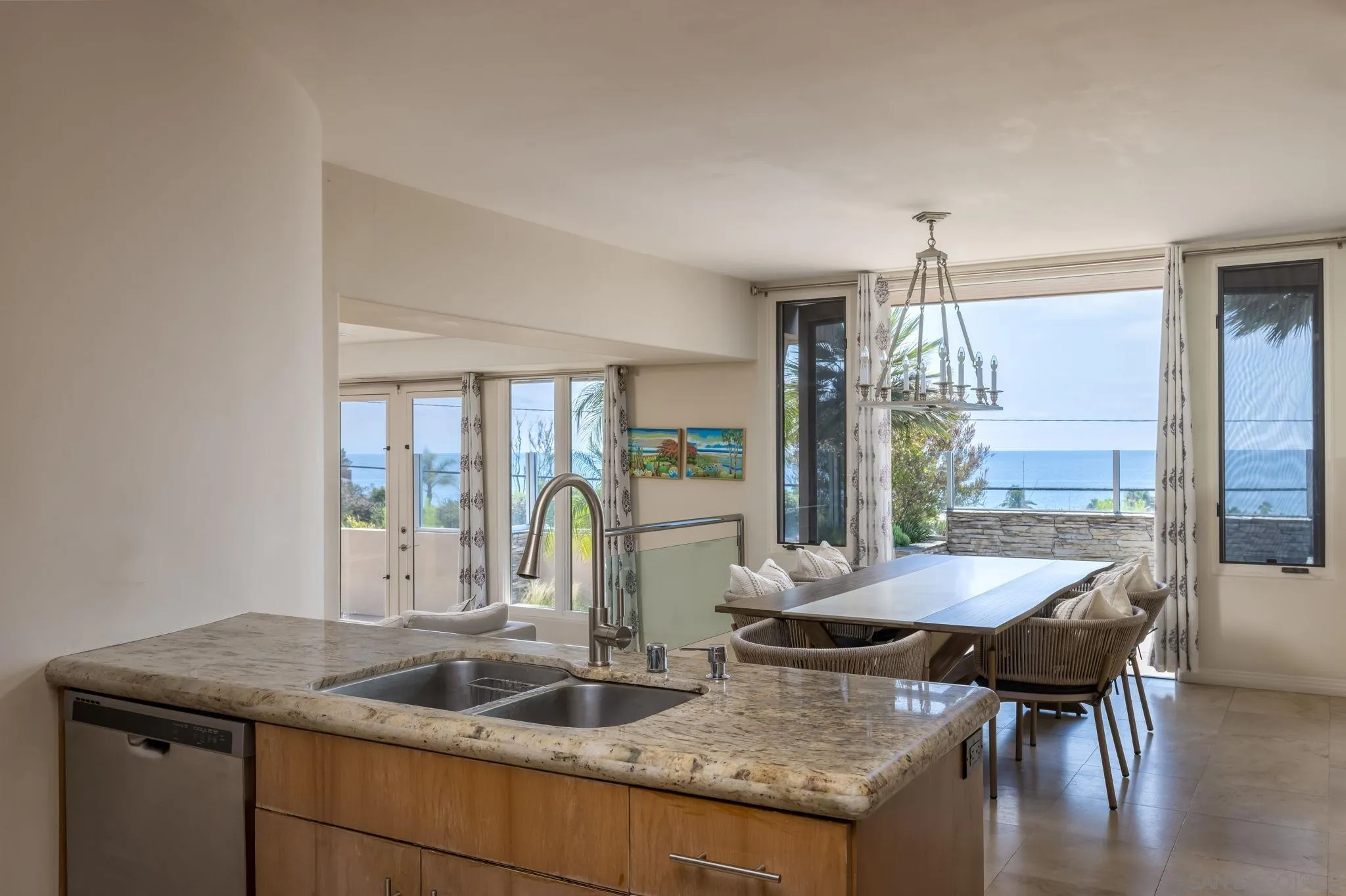 1722 Seaview Avenue Del Mar, CA 92014 - Photo 12 of 31 a kitchen with granite countertop a table chairs and wooden floor