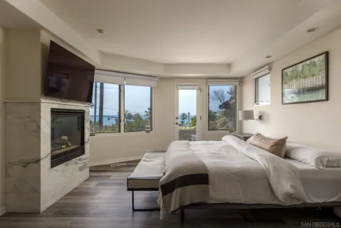 a bedroom with a bed and a fireplace