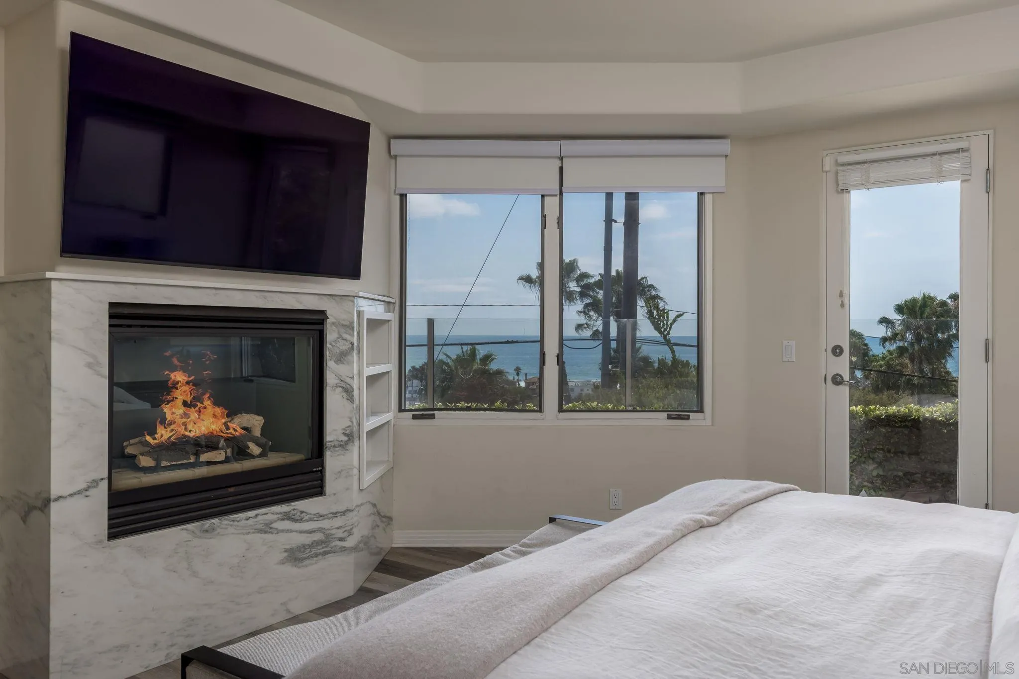 1722 Seaview Avenue Del Mar, CA 92014 - Photo 14 of 31 a bedroom with a fireplace and a painting on the wall