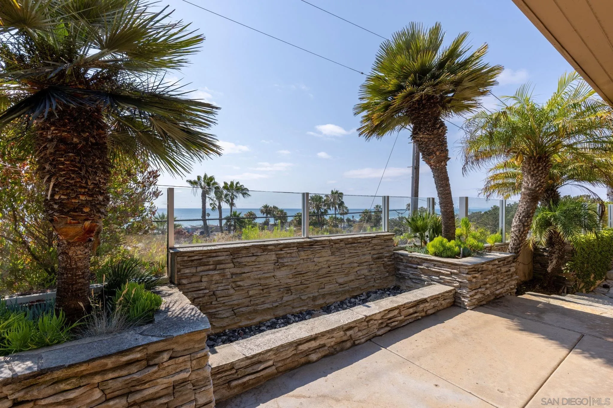 1722 Seaview Avenue Del Mar, CA 92014 - Photo 23 of 31 a view of a swimming pool with a garden and palm trees