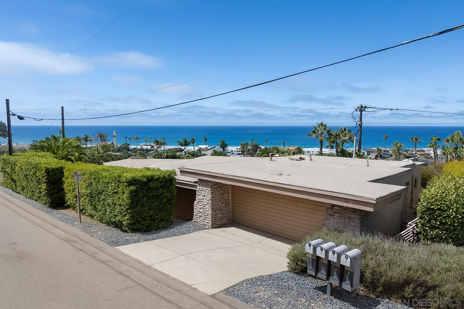 1722 Seaview Avenue Del Mar, CA 92014 - Photo 31 of 31 a view of a patio with couches and table under an umbrella