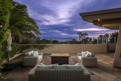 a view of roof deck with couches and wooden floor