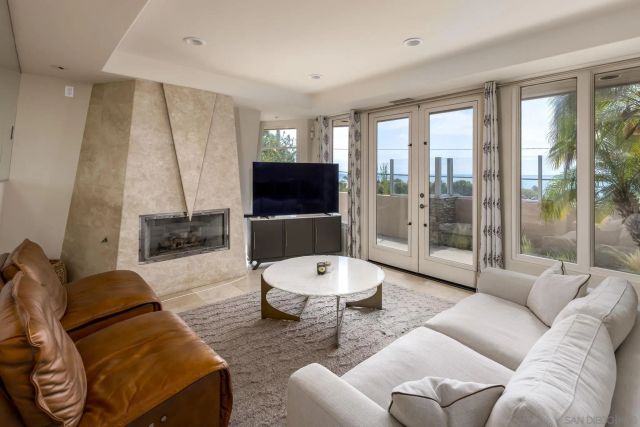 a living room with furniture a lamp and a flat screen tv