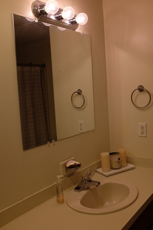39 Parlin Street, Unit 605 Everett, MA 02149 - Photo 18 of 21 a bathroom with a sink and mirror