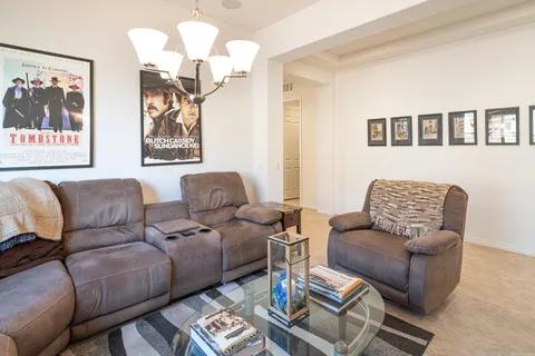 a living room with furniture a couch and paintings on the wall