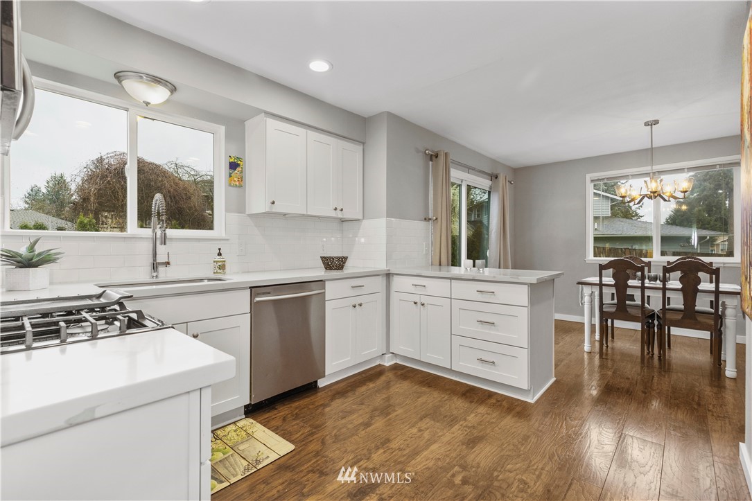 2612 170th Street Southeast Bothell, WA 98012 - Photo 6 of 21 a kitchen with white cabinets and appliances