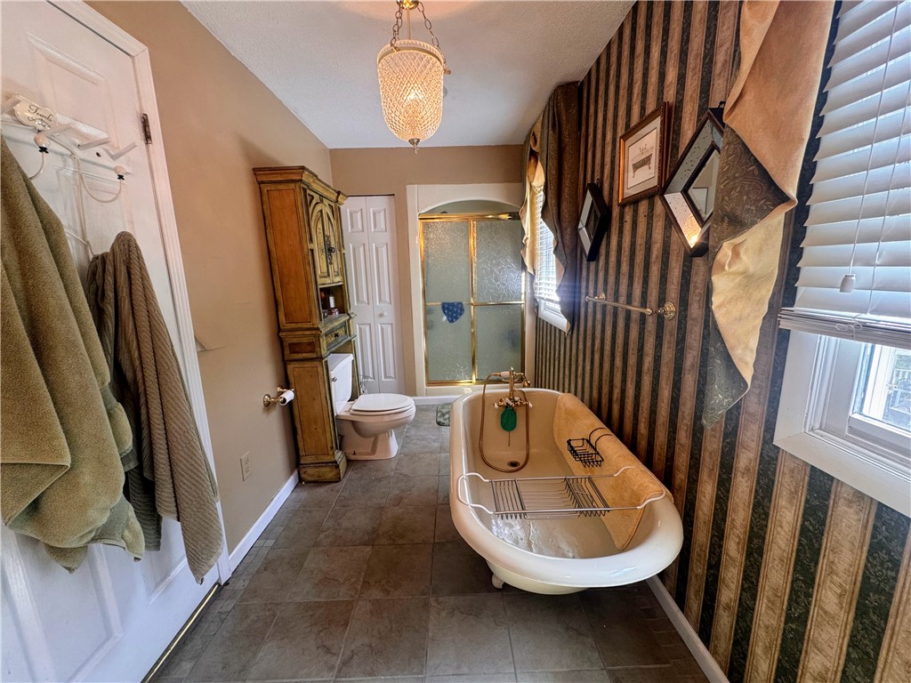 208 Knoxwood Court Anderson, SC 29621 - Photo 23 of 38 This private bath features a freestanding tub and a separate glass-enclosed shower, perfect for relaxation.