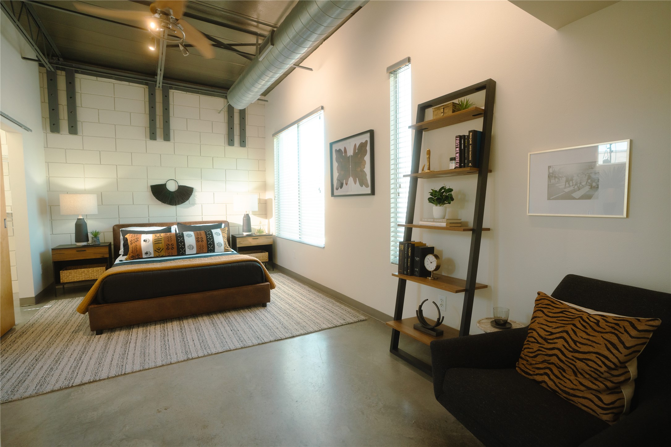 4801 South Congress Avenue, Unit H5 Austin, TX 78745 - Photo 2 of 39 Bedroom with finished concrete flooring and ceiling fan
