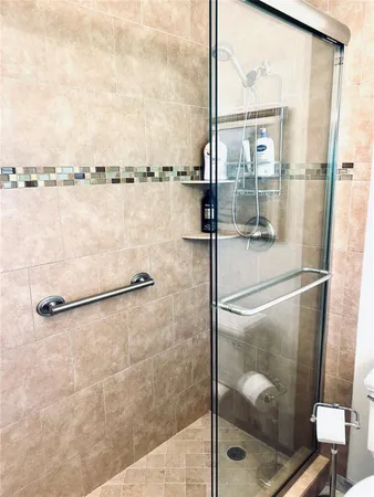 a bathroom with a glass shower door
