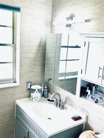 a bathroom with a sink and a window