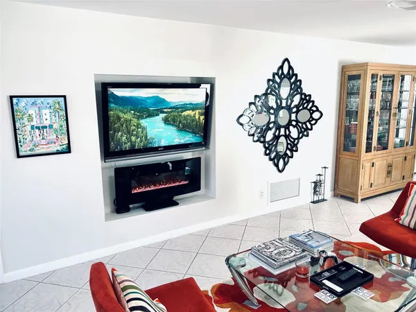 a living room with furniture a rug and a fireplace