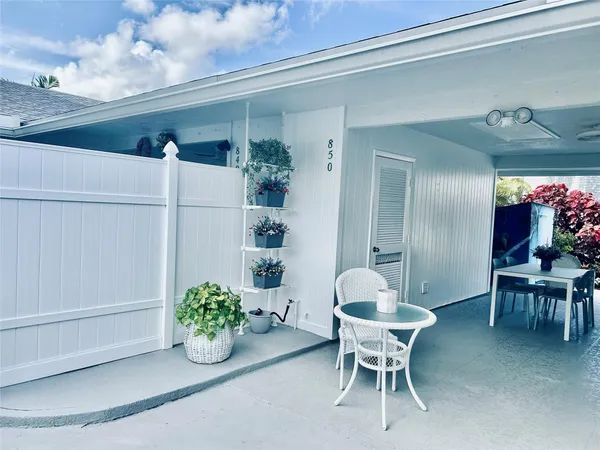a outdoor space with a table and chairs