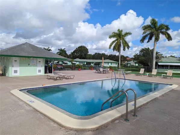 a view of a swimming pool with a lounge chair