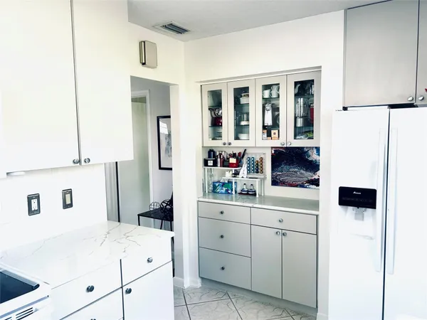 a kitchen with a sink and refrigerator