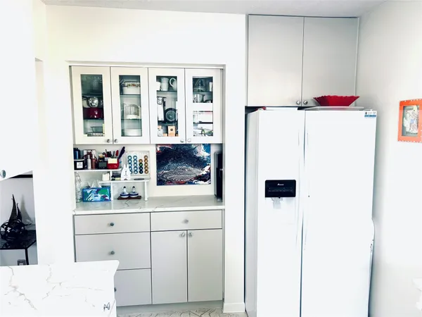 a kitchen with a refrigerator a stove and a microwave