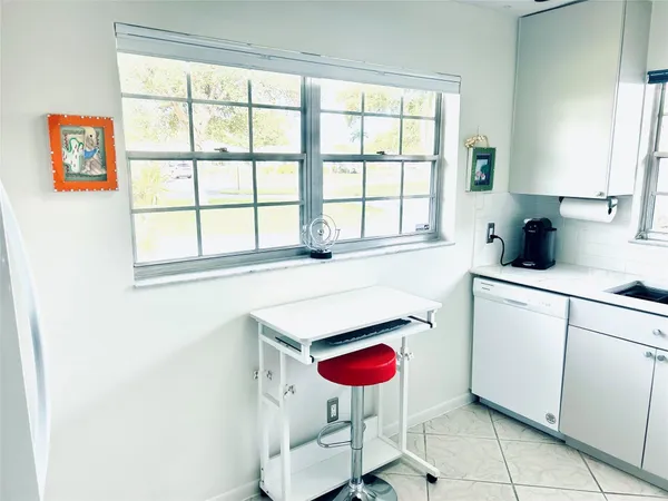 a kitchen with a sink cabinets and window