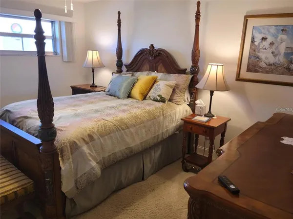 a bed room with a bed and a lamp