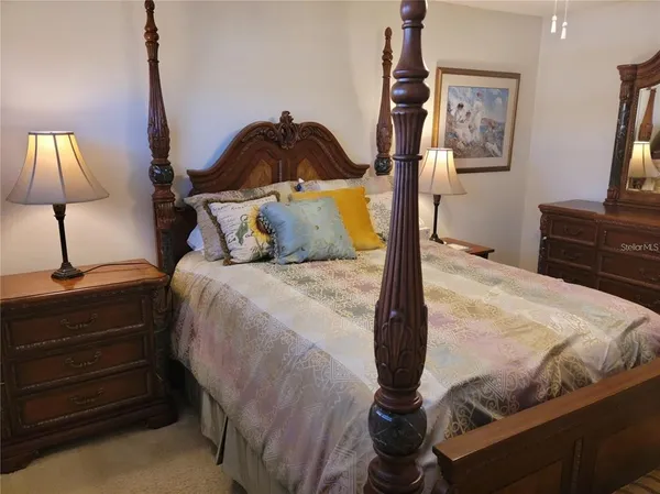 a bedroom with a bed and a lamp on table