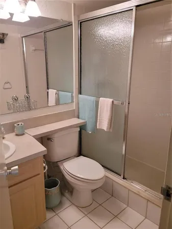 a white toilet sitting next to a bathroom sink