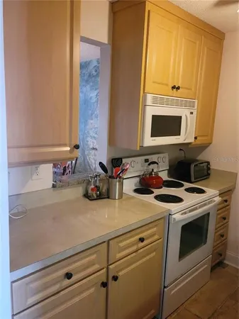 a view of a stove top oven a sink and dishwasher