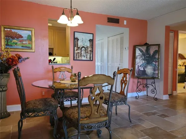 a view of a dining room with furniture and chandelier