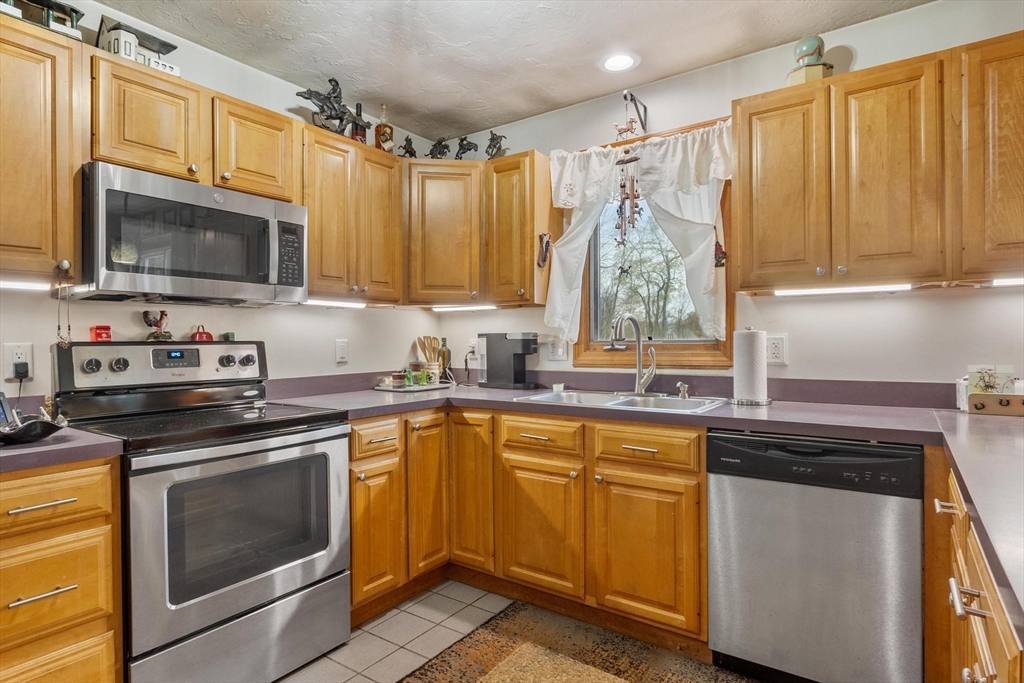 340 Ball Hill Road Princeton, MA 01541 - Photo 22 of 41 a kitchen with a stove microwave oven sink and cabinets