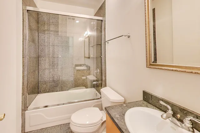 a bathroom with a toilet a sink and bathtub