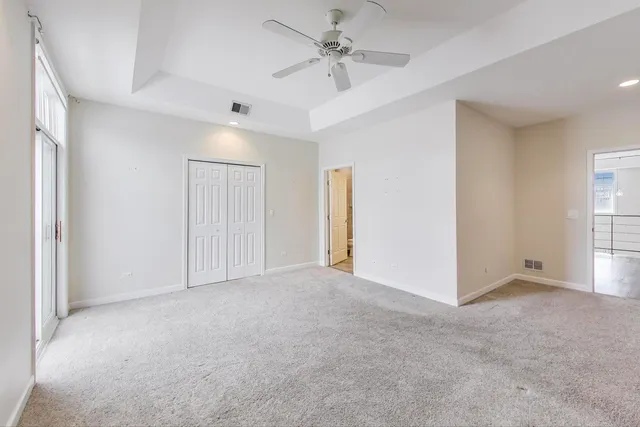 a view of an empty room with a ceiling fan