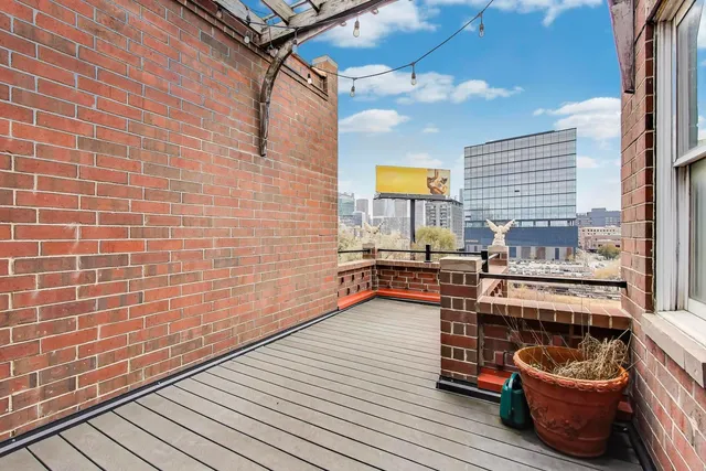 a view of a patio with chairs and potted plants