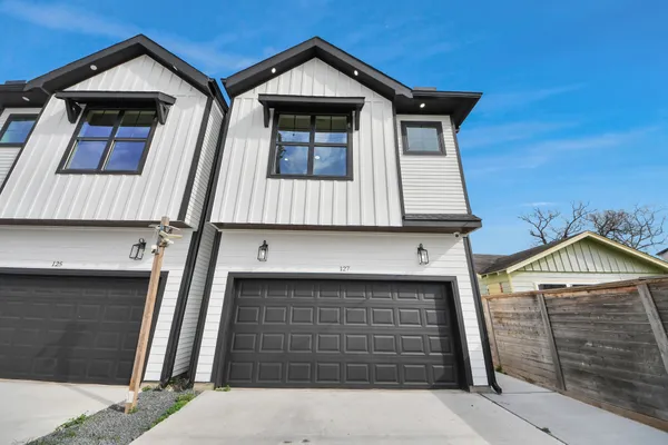 a front view of a house with garage