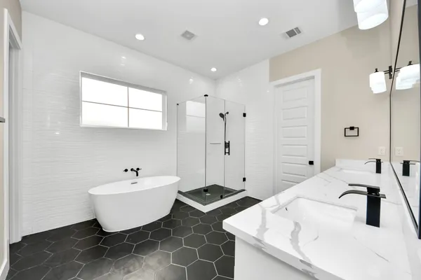 a bathroom with a double vanity sink mirror and
