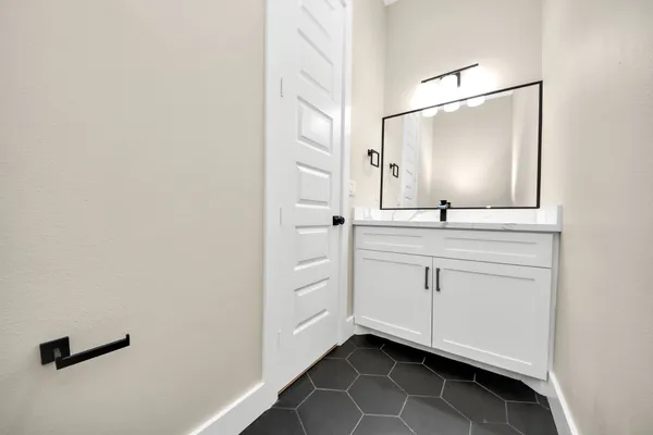 a bathroom with a sink a mirror and a vanity