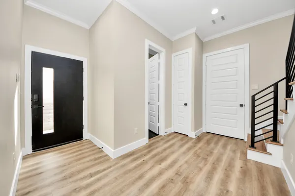 a view of a livingroom with wooden floor and closet
