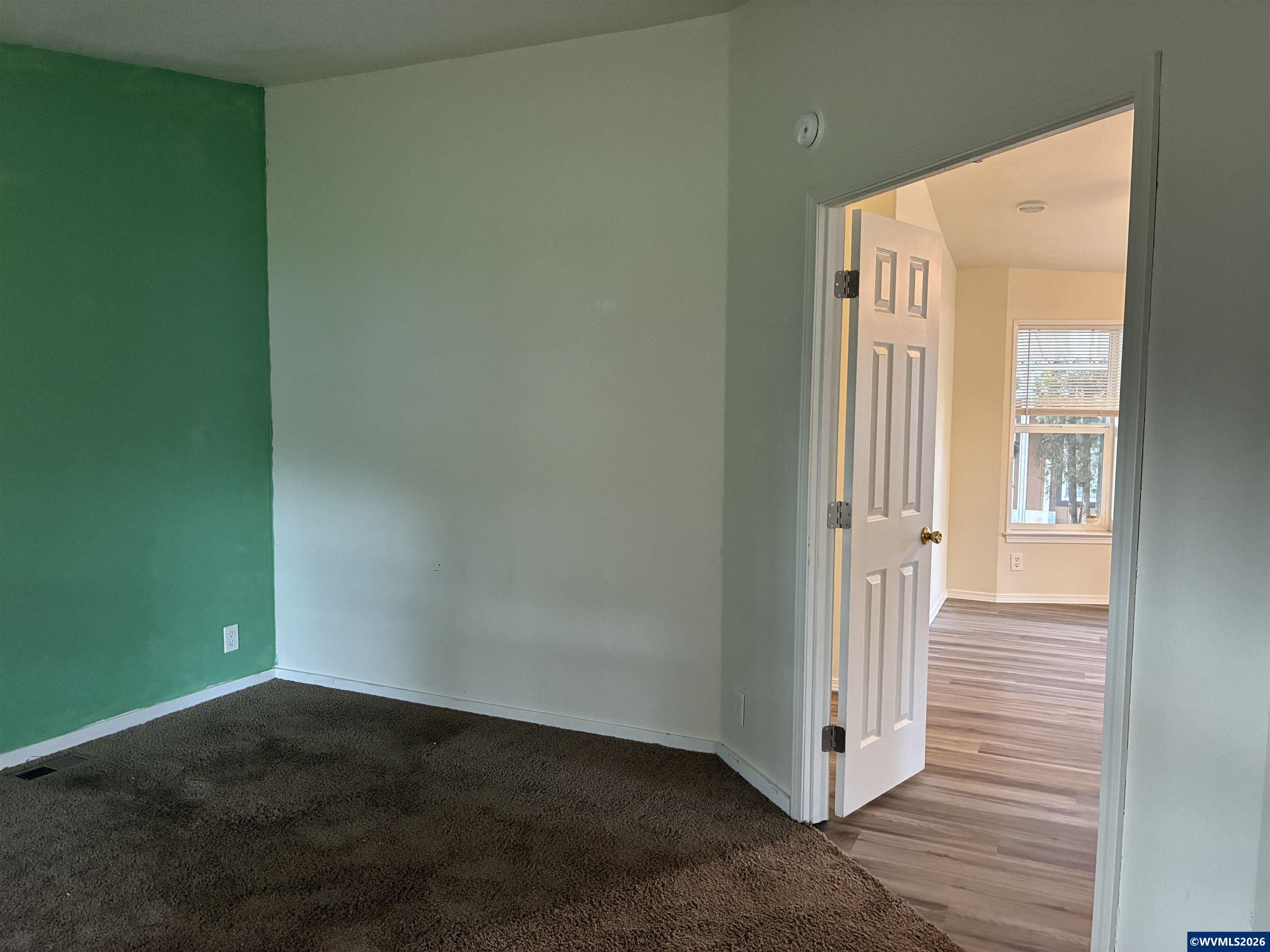 2000 Robins Lane Southeast, Unit 7 Salem, OR 97306 - Photo 14 of 39 an empty room with wooden floor and windows