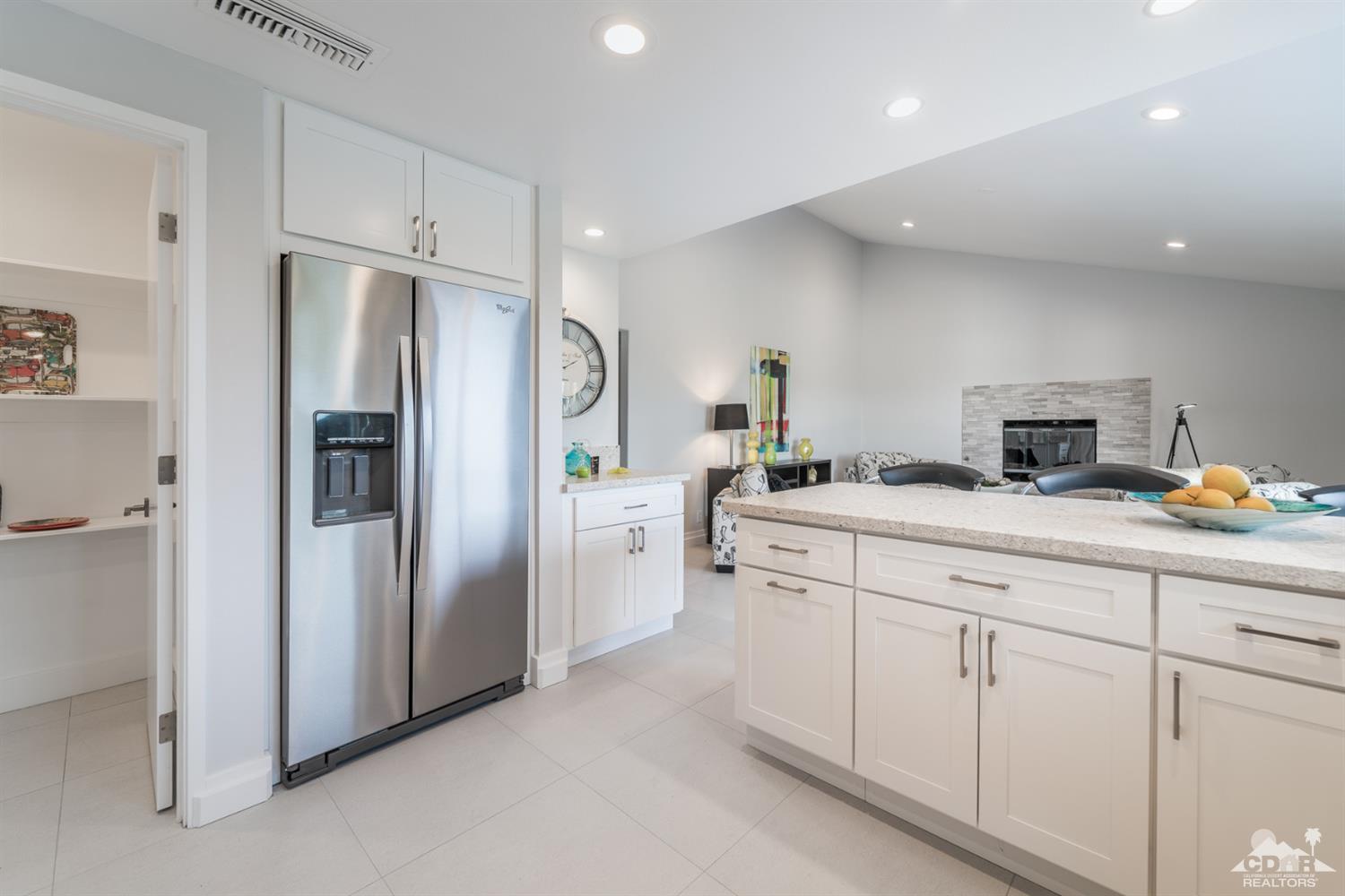 72845 Haystack Road Palm Desert, CA 92260 - Photo 16 of 39 a kitchen with white cabinets and refrigerator
