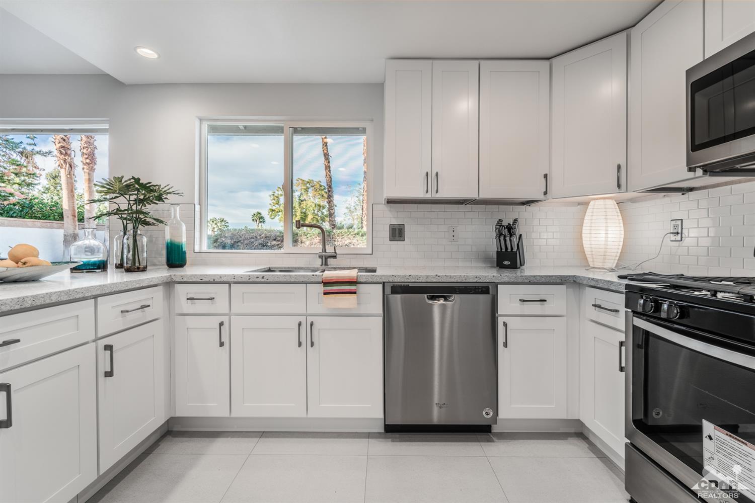 72845 Haystack Road Palm Desert, CA 92260 - Photo 17 of 39 a kitchen with white cabinets appliances and a sink