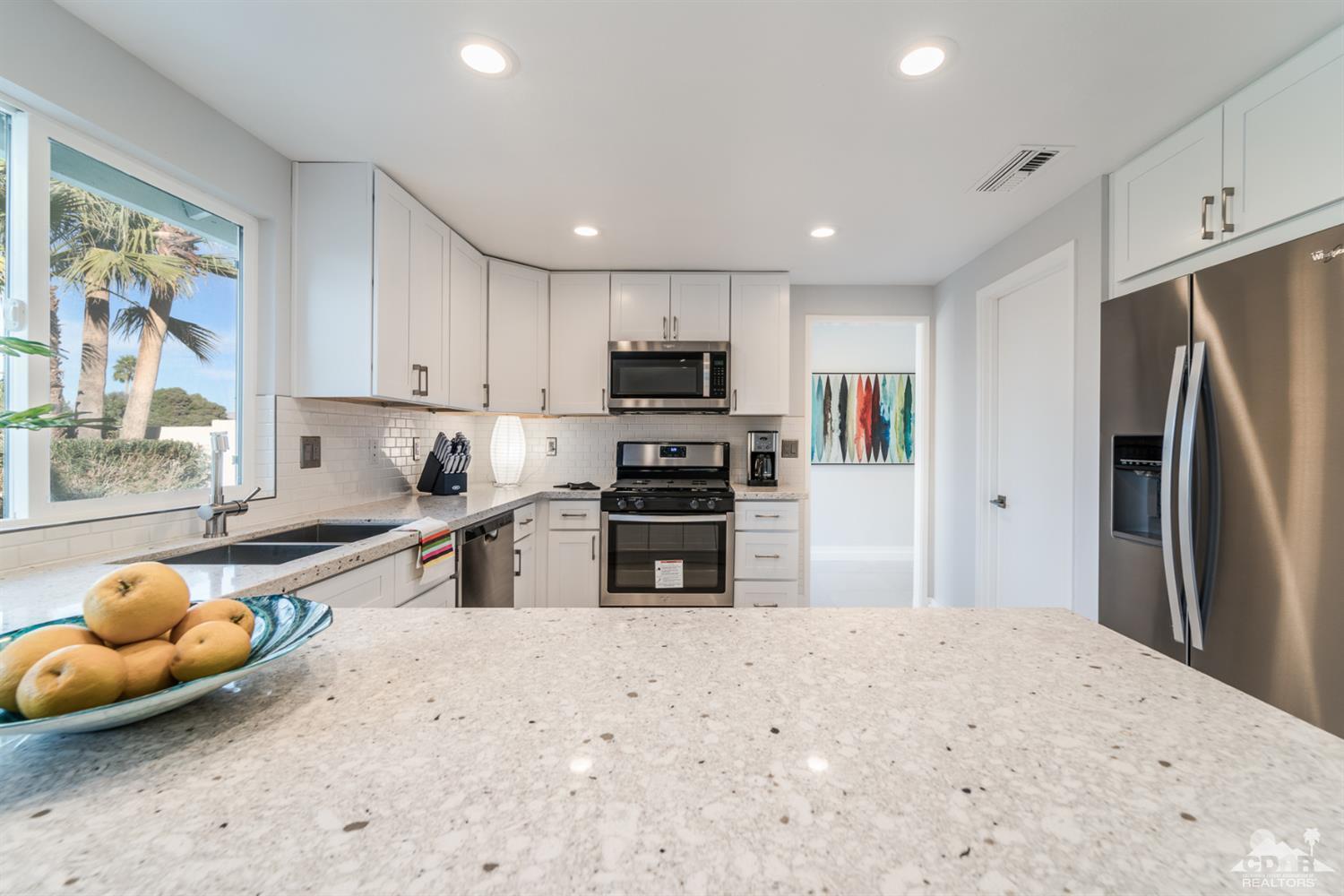 72845 Haystack Road Palm Desert, CA 92260 - Photo 18 of 39 a kitchen with stainless steel appliances a refrigerator sink and microwave