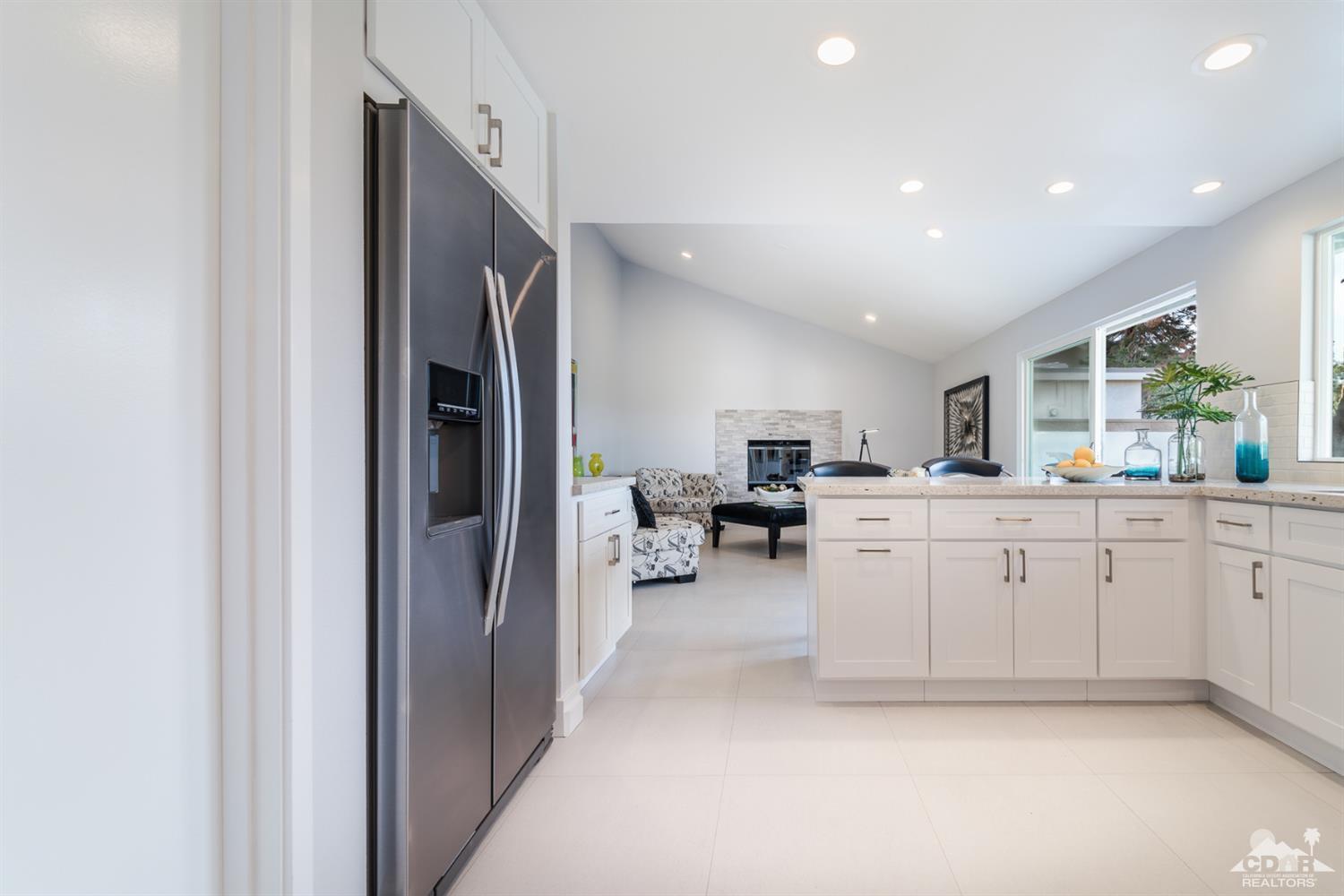 72845 Haystack Road Palm Desert, CA 92260 - Photo 19 of 39 a large white kitchen with a large window