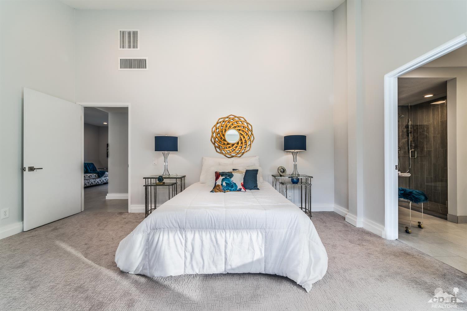 72845 Haystack Road Palm Desert, CA 92260 - Photo 22 of 39 a bedroom with a bed and a lamp on table