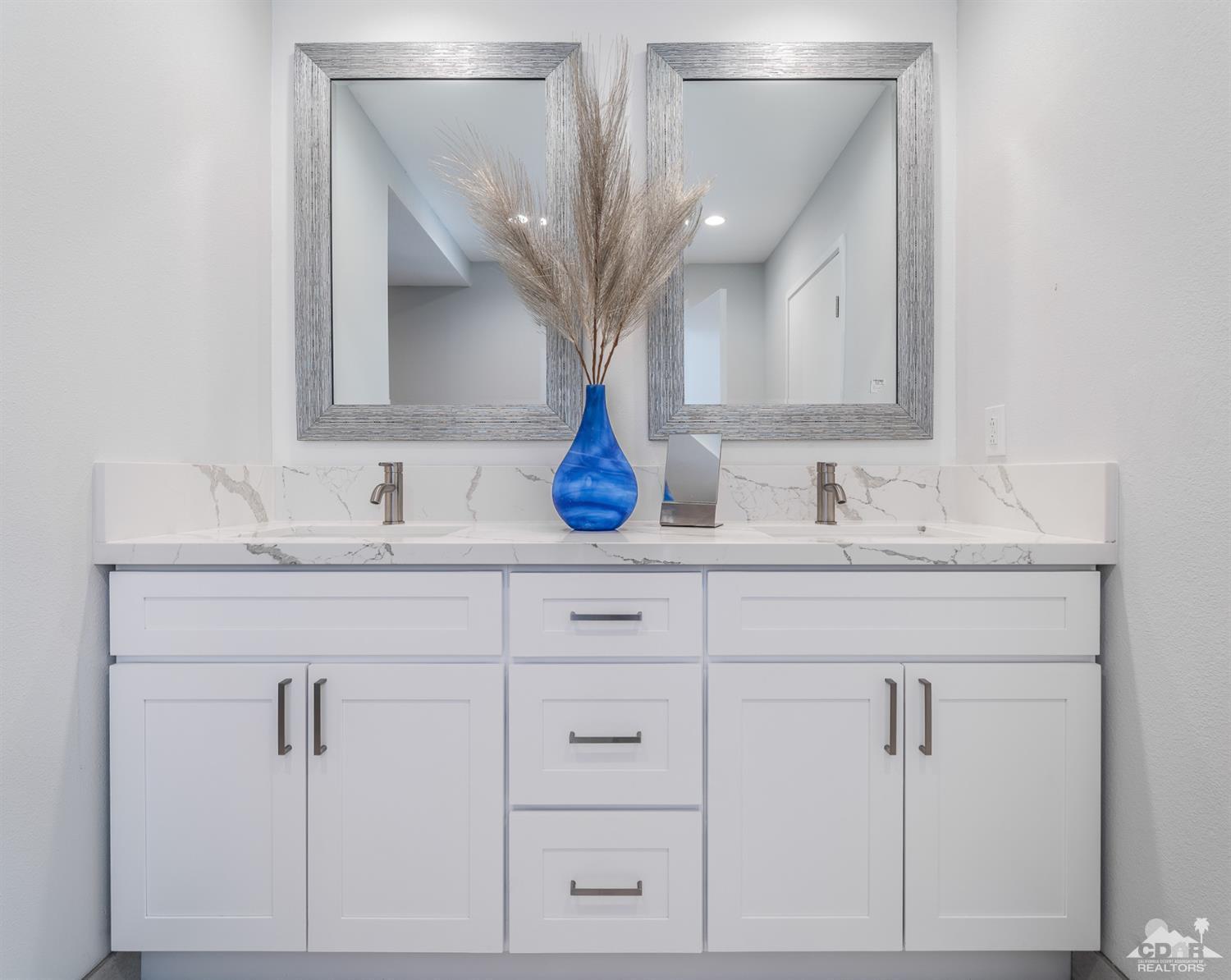 72845 Haystack Road Palm Desert, CA 92260 - Photo 25 of 39 a bathroom with cabinets and mirror